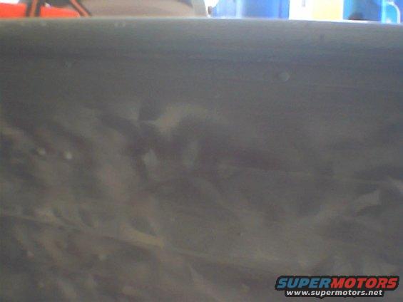 Gray painted metal surface with Supermotors.net watermark